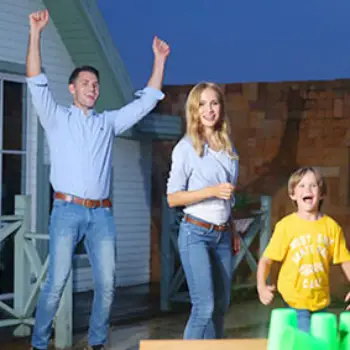 image of 2 parents and a son being super happy